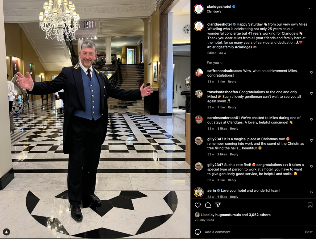 Photo of a concierge in a professional uniform, standing at a reception desk with a welcoming smile for their luxury hotel marketing strategy.